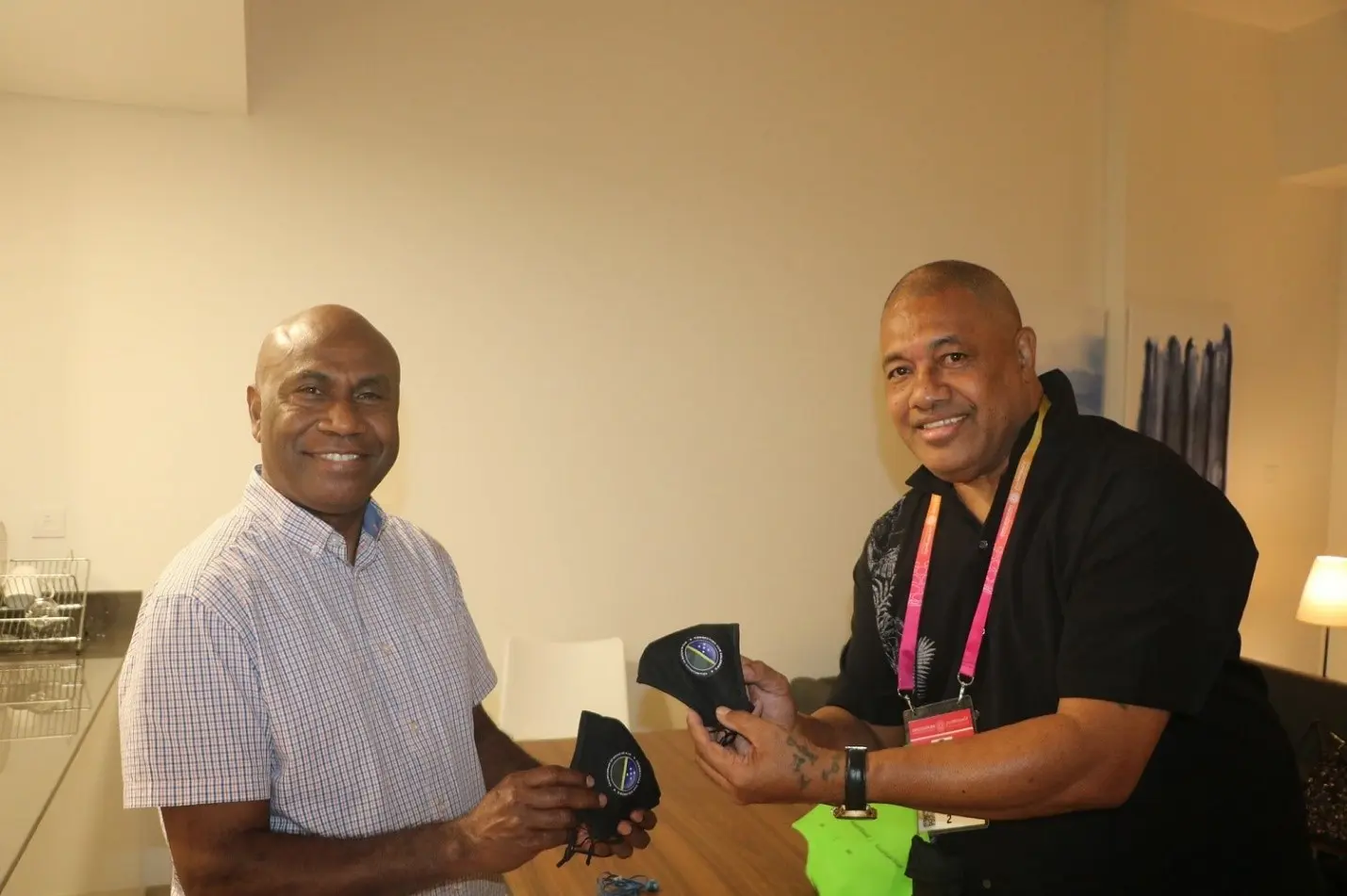 Commissioner General Ambassador, Moses Kouni Mose and Communications Volunteer, Mr. Kelepi Abariga display customized Solomon Islands face masks at the Solomon Islands Pavilion.