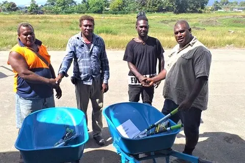 Two Noni Farmers receive support from GP extension staff.