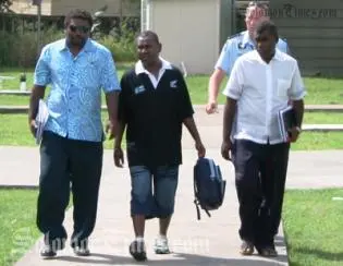 Philip Bobongi (centre) is escorted by officers from the RSIPF's Corruption Squad to appear before Honiara Magistrate's Court for alleged money laundering offences.