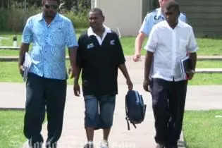 Philip Bobongi (centre) is escorted by officers from the RSIPF's Corruption Squad to appear before Honiara Magistrate's Court for alleged money laundering offences.