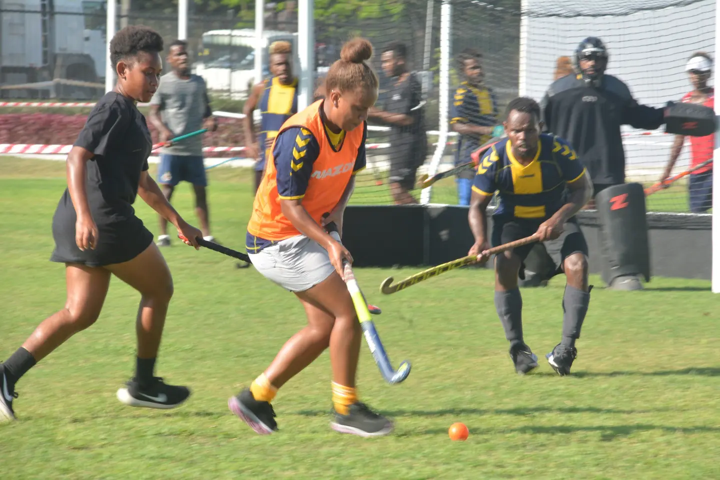 The girls hockey team in action at the SINIS sports ground.