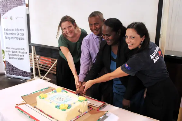 Ministry of Education and key partners cutting the celebratory cake.