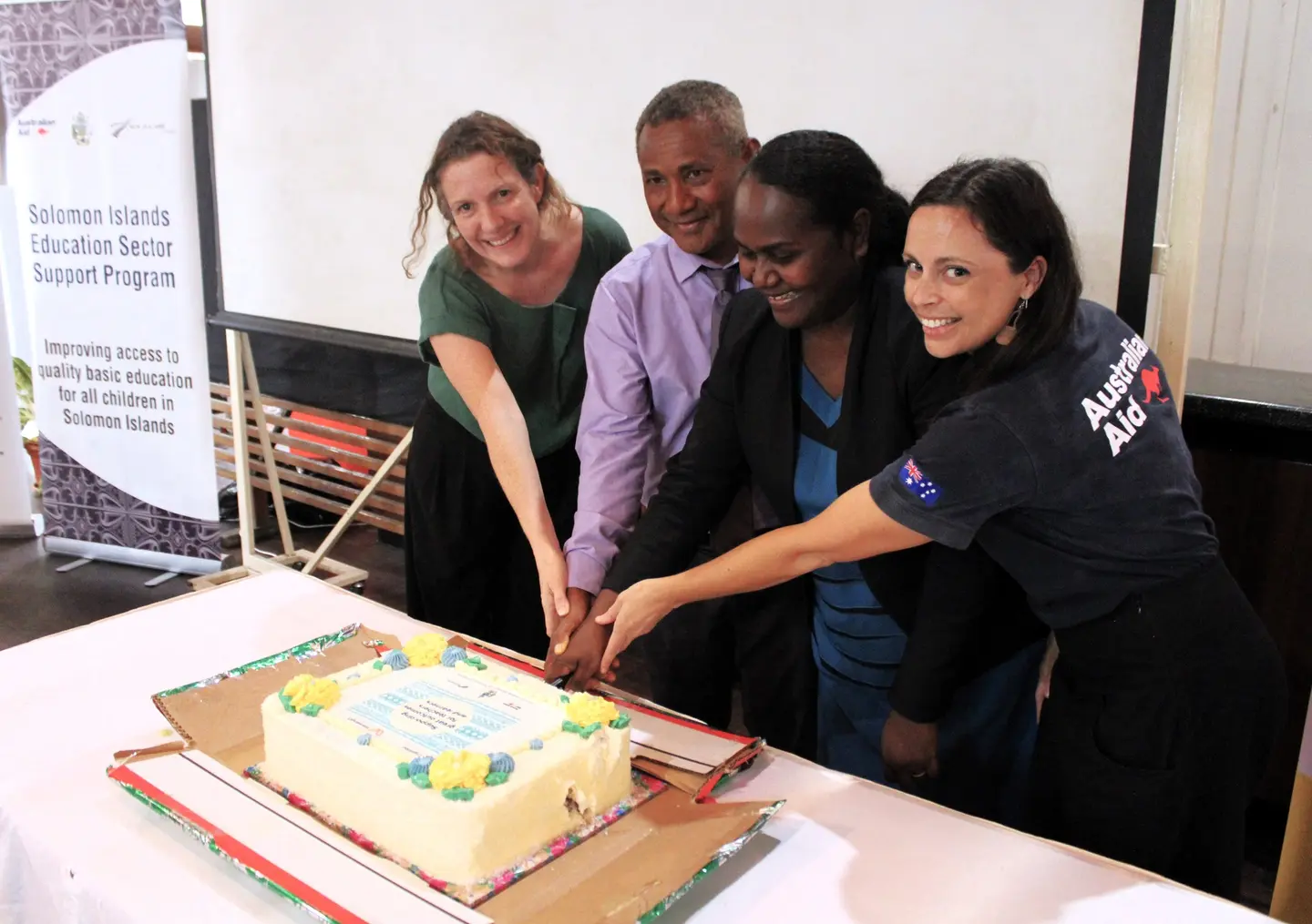 Ministry of Education and key partners cutting the celebratory cake.