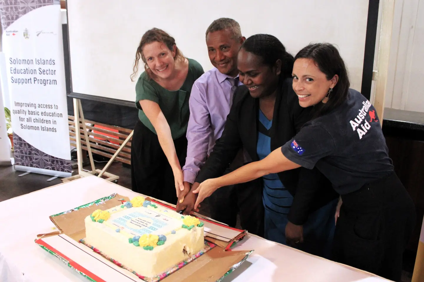 Ministry of Education and key partners cutting the celebratory cake.