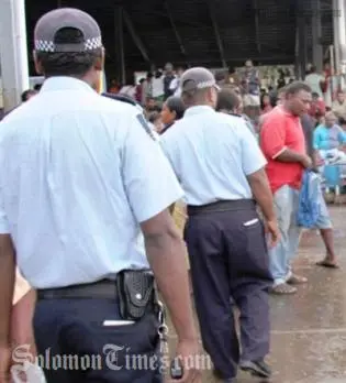 Police officers patrolling the Honiara central market yesterday.