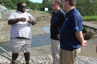 Local engineer, Lemuel Siosi explains the road works to Mr. Marles.