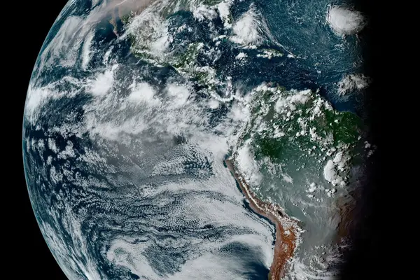 Waning gibbous Earth taken by the GOES-16 satellite on Sept. 11, 2020. Smoke from fires in the Amazon and Pantanal of Brazil dominates South America. A vast vector of smoke expands across North America and the Pacific from West Coast wildfires.