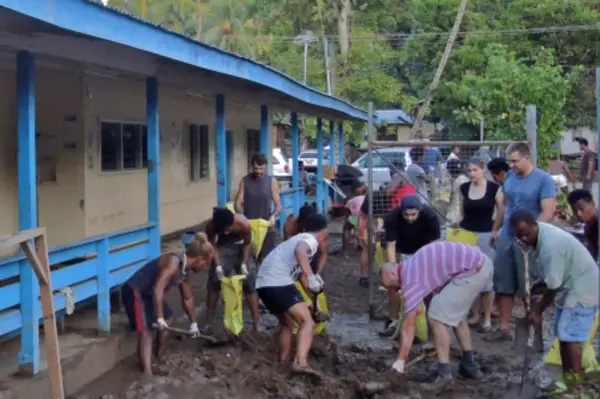 For six hours, the White Demons and their Australian friends including the Australian High Commissioner shoveled nearly 200 bags of mud and put on a BBQ breakfast for the community.