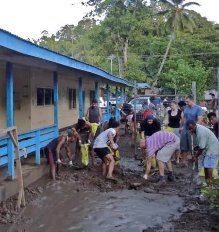 For six hours, the White Demons and their Australian friends including the Australian High Commissioner shoveled nearly 200 bags of mud and put on a BBQ breakfast for the community.