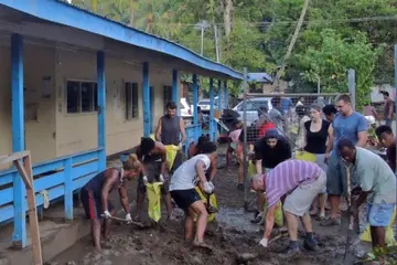 For six hours, the White Demons and their Australian friends including the Australian High Commissioner shoveled nearly 200 bags of mud and put on a BBQ breakfast for the community.
