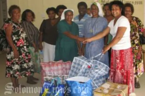 Madam Sikua (second right) hands over donation to the Centre.