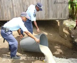 Police pouring out litres of home brewed Kwaso destined for the streets of Honiara.