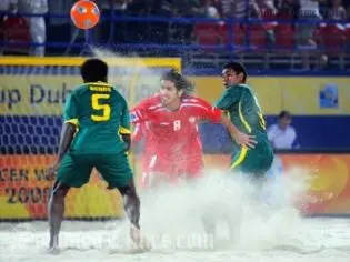 Rami Al Mesaabi of UAE holds off Hickly Rence (L) and Franco Nee of the Solomon Islands during the Group C FIFA Beach Soccer World Cup match between Solomon Islands and UAE.