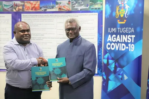 Prime Minister Sogavare during the official handover of the ESP to the Minister of Finance and Treasury Harry Kuma.