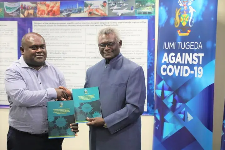 Prime Minister Sogavare during the official handover of the ESP to the Minister of Finance and Treasury Harry Kuma.