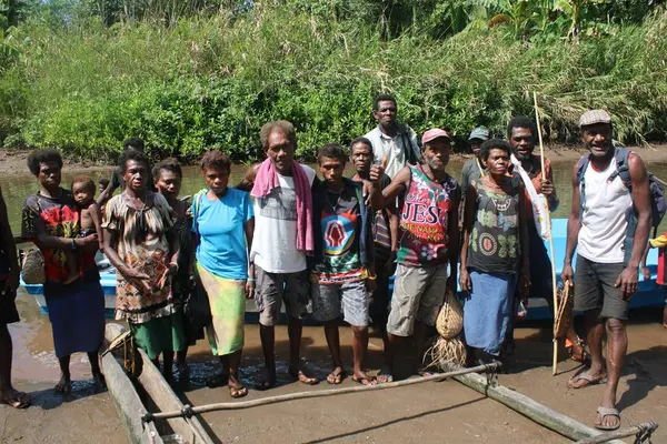 Malefo Anisi (centre in white shirt) with villagers that saved him after 47 days at sea.