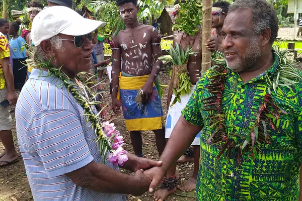 Mr. Chanel Iroi (R), the SGP's National Steering Committee Chairperson and the Deputy Secretary-Technical for the Ministry of Environment, Climate Change, Disaster Management and Meteorology (MECDM), acknowledged the community’s hard work and the successful implementation of the project.