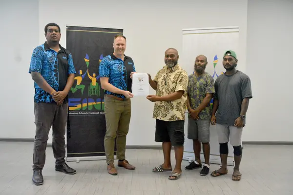 Signing of MOU between SINIS and Solomon Islands powerlifting, with representatives of both organizations.