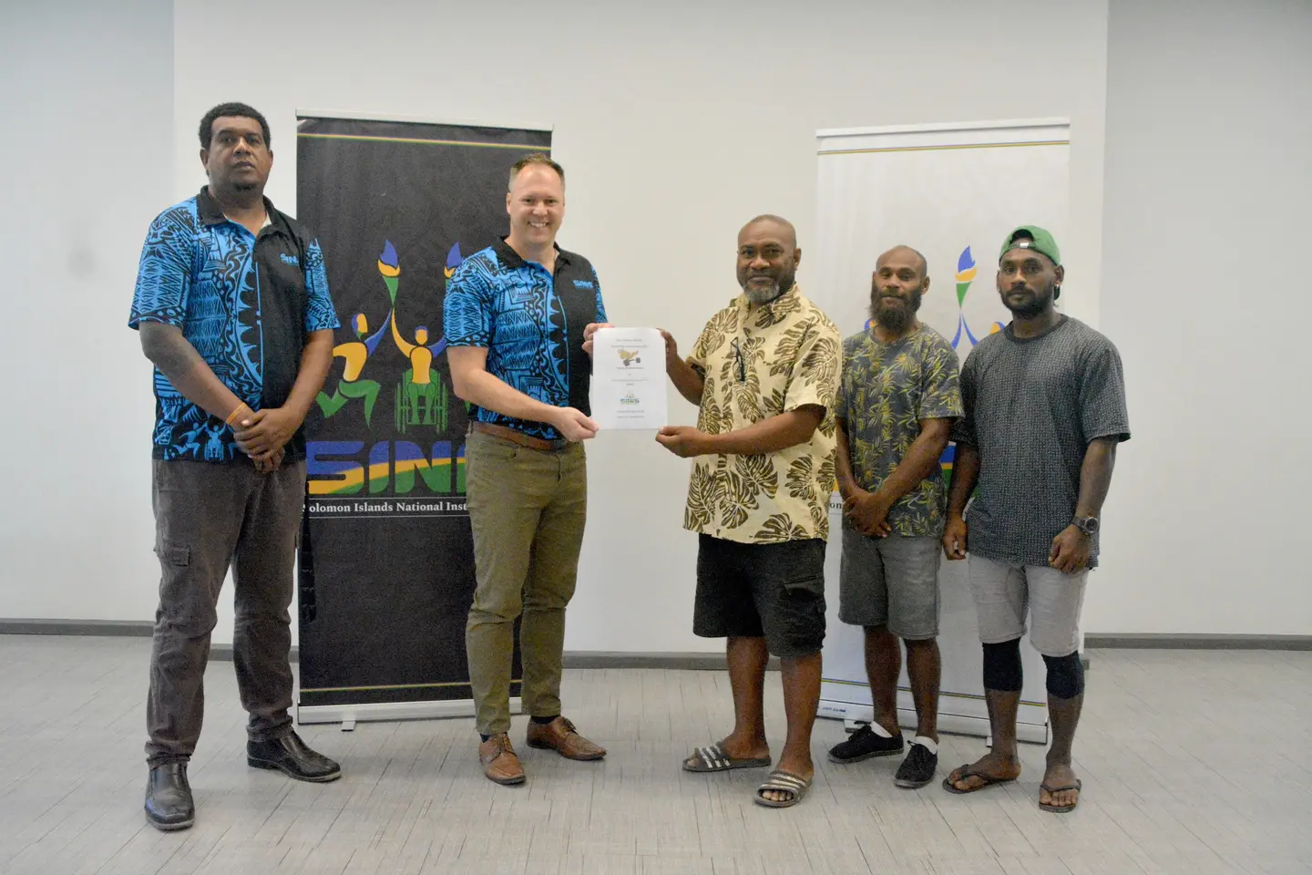 Signing of MOU between SINIS and Solomon Islands powerlifting, with representatives of both organizations.