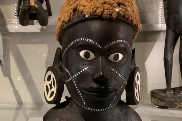 The black pigment is in sharp contrast to the vibrant colour of her hair and the silver markings on her face.