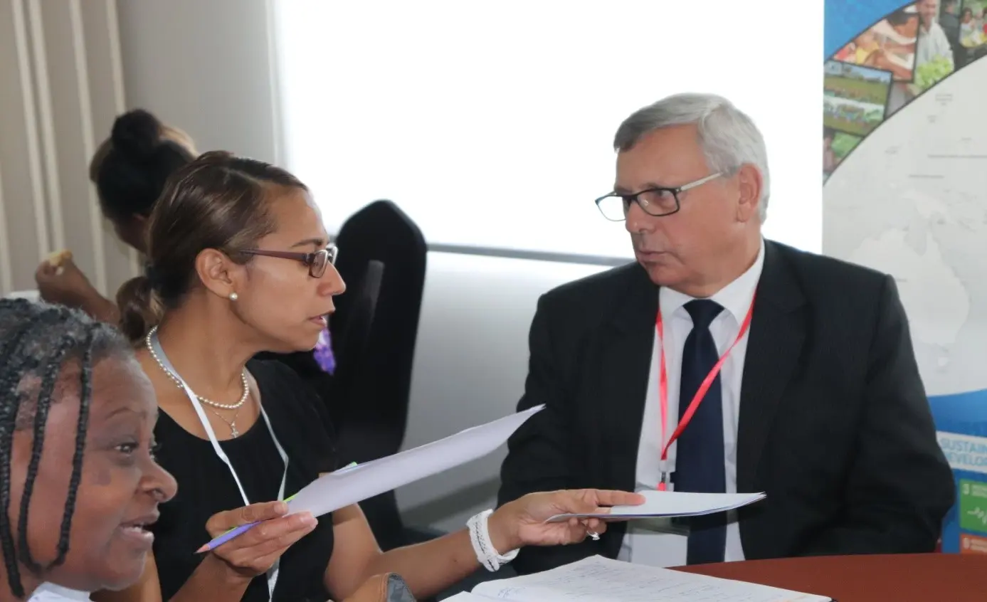 Mr. Howard Lawry, Public Solicitor (right) discusses with Andie Driu, Prosecution Advisor of Police Prosecutions Department RSIPF.