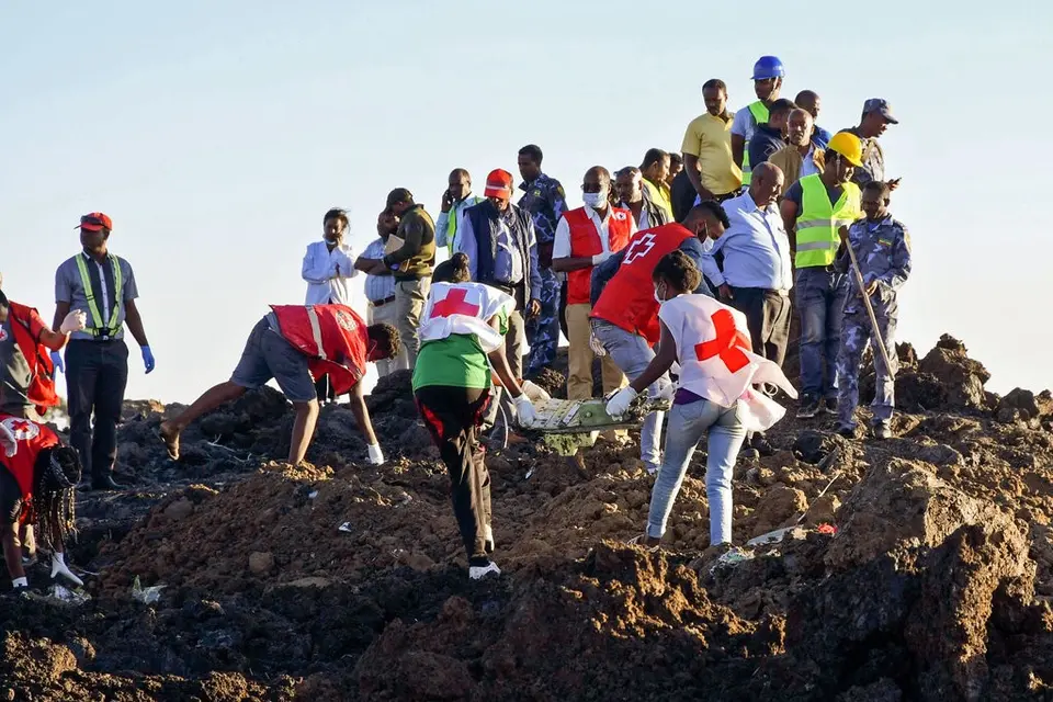 Rescue workers at the site of Ethiopia Airlines Flight 302 crash on Sunday, where more than 150 people were killed.