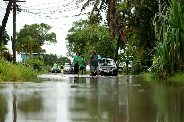 Residents wade through the flooded streets in Fiji&#39;s capital city of Suva on December 16, 2020, ahead of super cyclone Yasa.