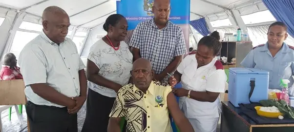 Supervising Premier Hon. Isaac Tatapu ready to receive his vaccination with which was witnessed by (back row from left) MHMS Director Planning Mr. Ivan Ghemu, Health PS Mrs Pauline McNeil and Western Provincial Health Director Dr Dickson Boara.