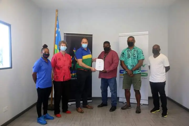 SINIS Performance Manager (Team Sports) Amanda Korinihona, NSC CEO Allison Burchell, SINIS Executive Director Aaron Alsop handing over the signed document to SIRUF President George Tema, SIRUF CEO Alivereti Mocelotu, and SIRUF Development Officer Godfrey Salo.